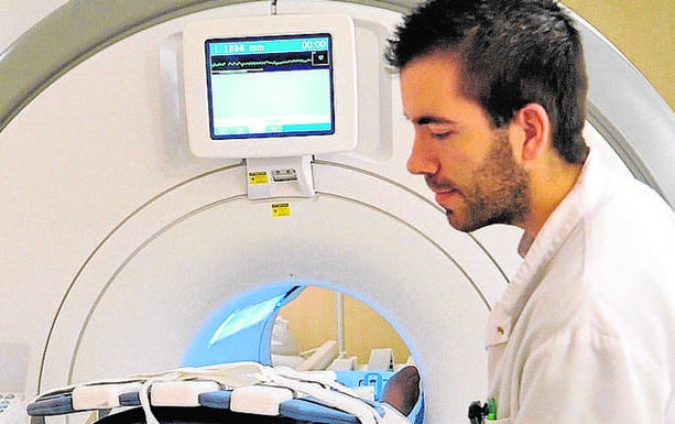 Un profesional prepara a un paciente para una resonancia