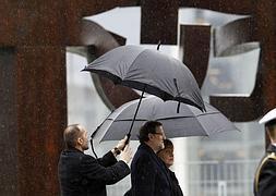 Rajoy y Merkel, bajo los paraguas, en la ceremonia de bienvenida en Berlín. Foto: Reuters/