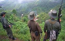 Guerrilleros de las FARC, en una colina de El Berlín, en el estado de Caquetá, al sur de Colombia, en una imagen de 1998. En la imagen pequeña, Lorenzo Ayestaran, uno de los señalados como participantes en el entrenamiento en la selva con la guerrilla colombiana. :: AP/