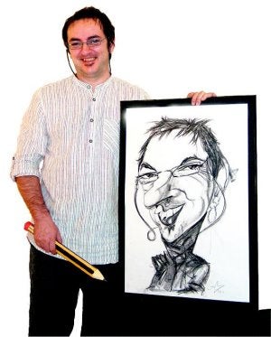 Carlos Medrano, con una caricatura suya. :: LV/