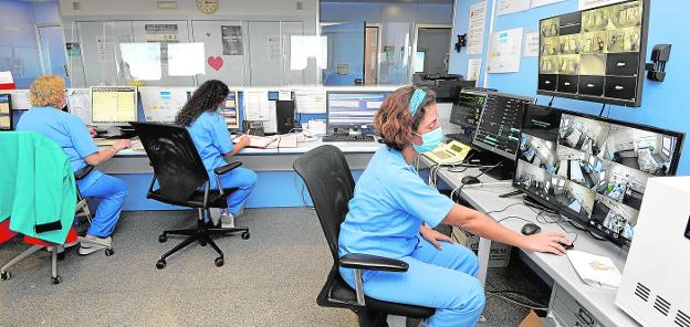 A healthcare provider checks the status of patients at the Reina Sofía's Covid plant through monitors. 