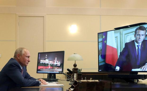 Russian President Vladimir Putin meets with French President Emmanuel Macron.  .