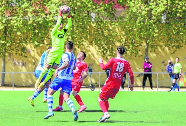 Gabri, El Palmar goalkeeper, catches a ball in yesterday's game. 
