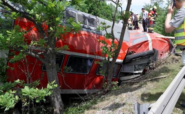 Rescue services try to get the passengers out of the derailed train.