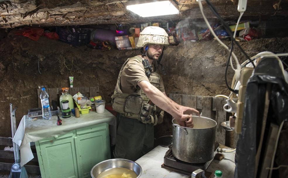In the kitchen.  Petro Dmitrovich, alias Satan, cooks inside the trench for his battalion mates outside Kherson.  Zigor aLDAMA