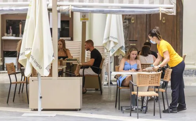 A waitress attends to some clients on a terrace in Murcia.