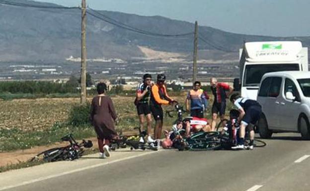 Cyclists run over in a file image. 