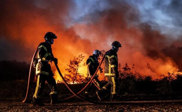 Firefighters work to extinguish the fires in southwestern France. 