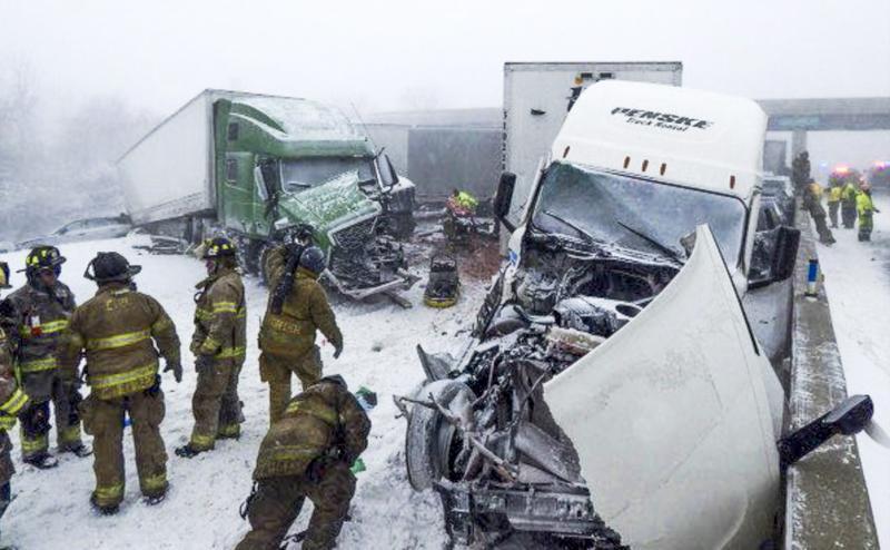 Firefighters try to free an Ohio highway where 46 vehicles collided
